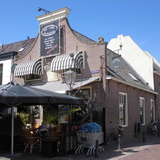 Het Rechthuis van Breukelen en Beukelerweerd, afgeknotte halsgevel, gebeeldhouwde steen, het pand zet zich voort in een hoger gebouw in de Herenstraat