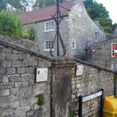 Wall incorporating C18 water supply point and a circa 1800 lamp standard