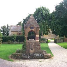 Water Conduit Circa 12 Metres North Of The Entrance To The Churchyard