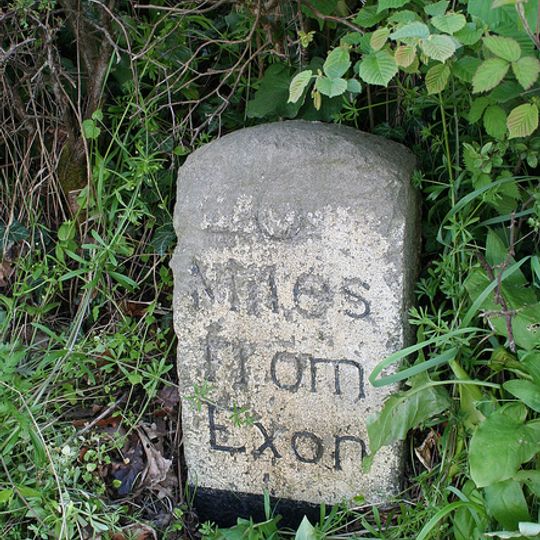 Milestone, Tedburn Road, 100m W of Woodlands Park mobile homes