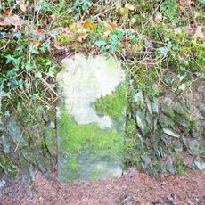Milestone, Budd's Wood, 500m W of Chelfham viaduct, on riverside road