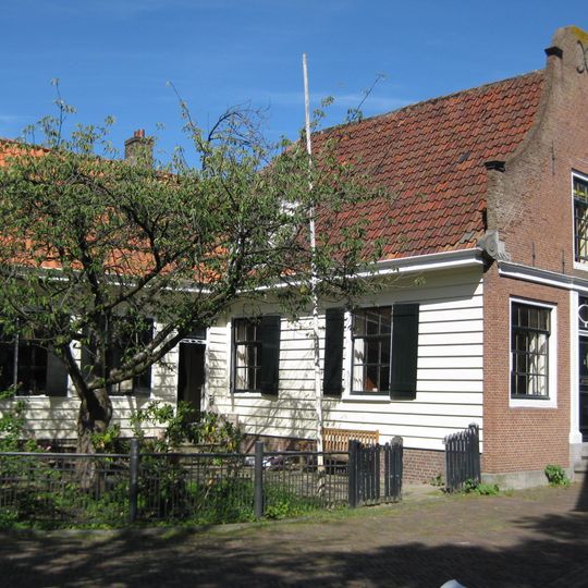 Houten huis met bakstenen halsgevel uit 1768 en houten puntgevel aan zijkant