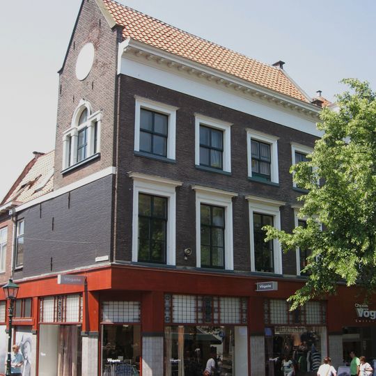 Hoekpand van parterre en twee verdiepingen met zadeldak tussen puntgevels. In de zijgevel drielichtsvenster met getoogd middenstuk en daarboven rond venster.