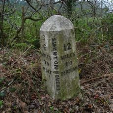 Milestone, 20yds S of turning to Swanton Novers