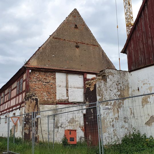 Wohnhaus mit winkelförmig angebautem Seitengebäude, Scheune mit daran angebautem Stallgebäude, weiteres Seitengebäude und Taubenhaus eines Vierseithofes sowie Vorgarten und Toreinfahrt an der Kirchgasse Dorfstraße 25