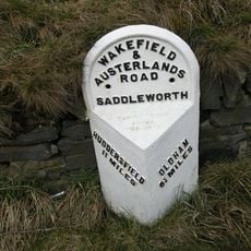 Milestone, ExYW down hill of sharp bend, opp SLOW on road