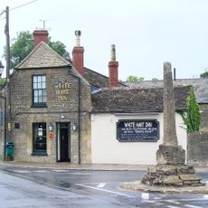 Medieval village cross at the junction of Park Place and the High Road 210m south of Gumstool Bridge