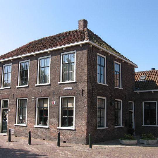 Hoekpand van begane-grond met verdieping en schilddak. Uitgebouwde kamer aan de Vlaardingerweg