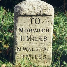 Milestone, NE side of X-rds beside village sign