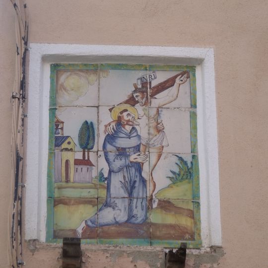 Ceramic panel of Saint Francis hugging Christ