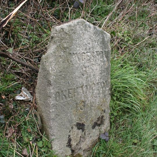 Milestone, W of Sprytown, on hill down to Tinhay