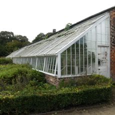 Stone wall and hothouses in Western Kitchen Garden