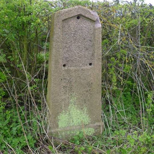 Milestone, W of The Grange and Globe Farm