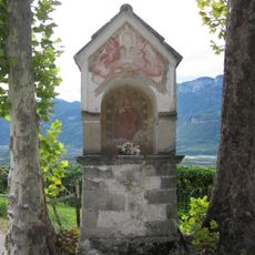 Wayside shrine underneath trees in Montan