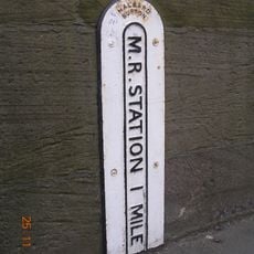 Milepost, Burton Bridge, just W of ramp to flood plain