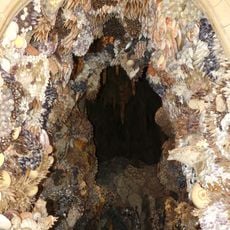 Grotto in recess right of lobby between stable yard and Chapel