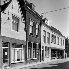 Huis met tot gepleisterde puntgevel gewijzigde trapgevel