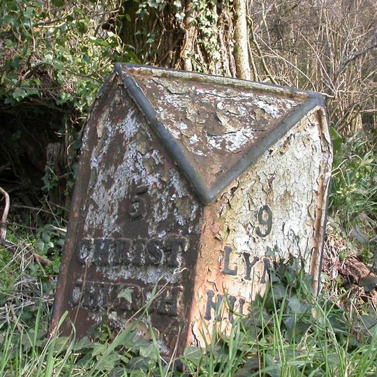 Milepost, N Hinton Farm; 50m N of entrance to Farm