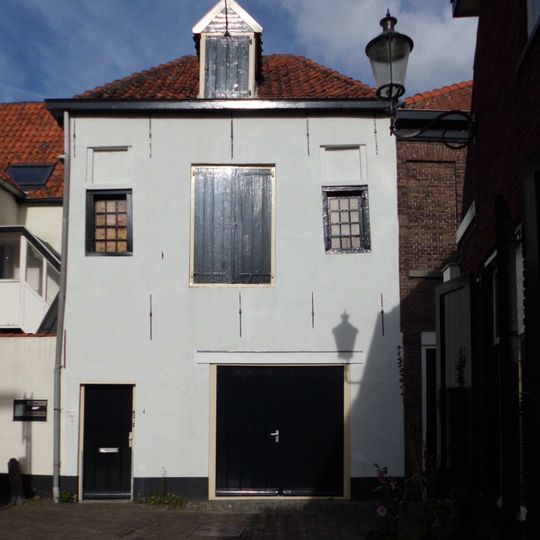 Gepleisterd pakhuis met rechte kroonlijst