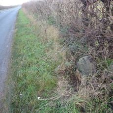 Milestone, 150yds E of Trouble House Inn, standing against drystone wall.