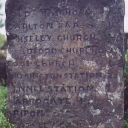 Milestone, Harrogate Road, just SW of jct with A660  at SE24114399