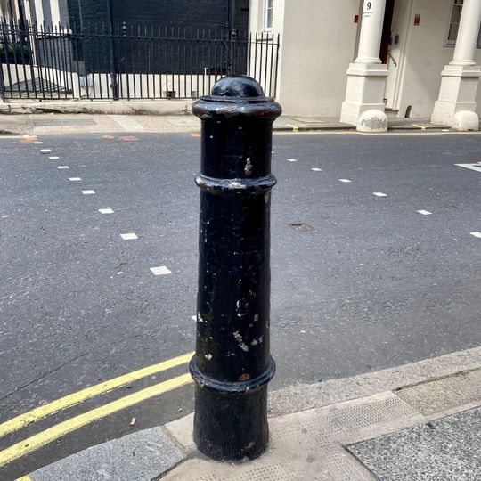 2 Bollards At South East And South West Corners Of Hill Street Intersection With South Audley Street