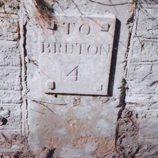 Milestone, Burt's Hill, S of village