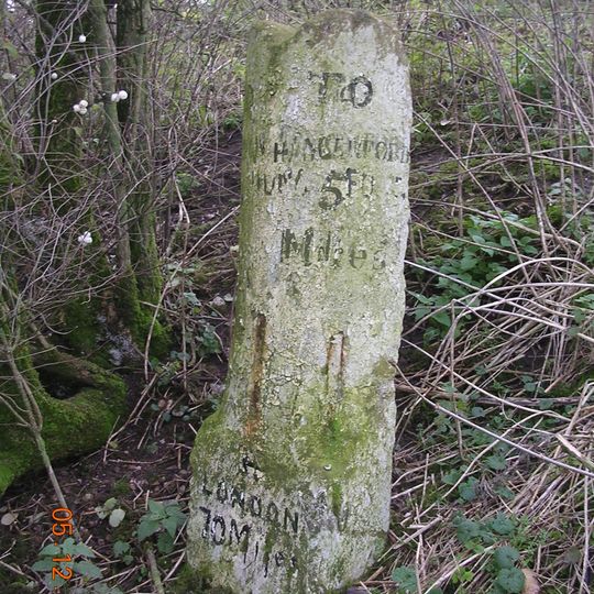 Milestone Below Fox And Hounds Buildings