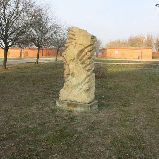 Kamenná plastika Cesta proměny v parku za kostelem Nanebevzetí Panny Marie v Mostě