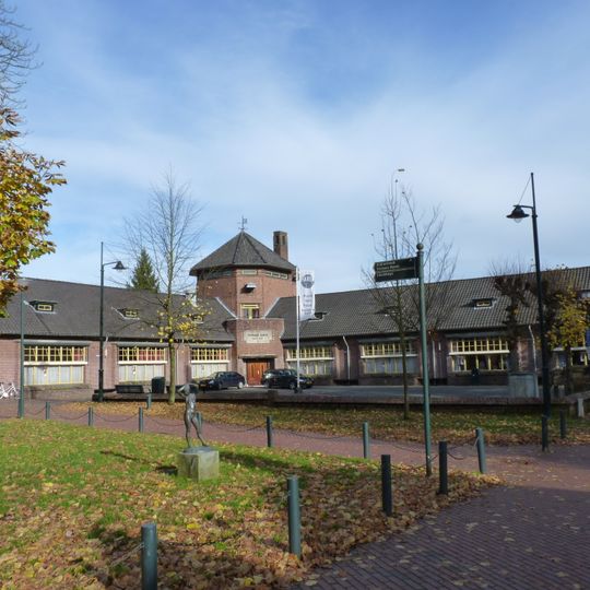 Openbare lagere school met ommuurd schoolplein in een stijl verwant aan de Amsterdamse School