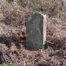 Milestone, on approach to old railway bridge