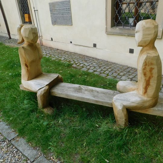 Lavička s postavami dívky a chlapce